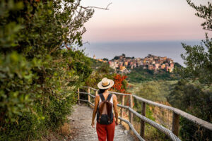 Female tourist walking towards Corniglia village, Beautiful town in Cinque Terre coast